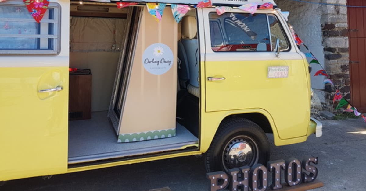 starting a campervan photo booth business image featuring yellow wesfalia camper with Magic Mirror photobooth inside