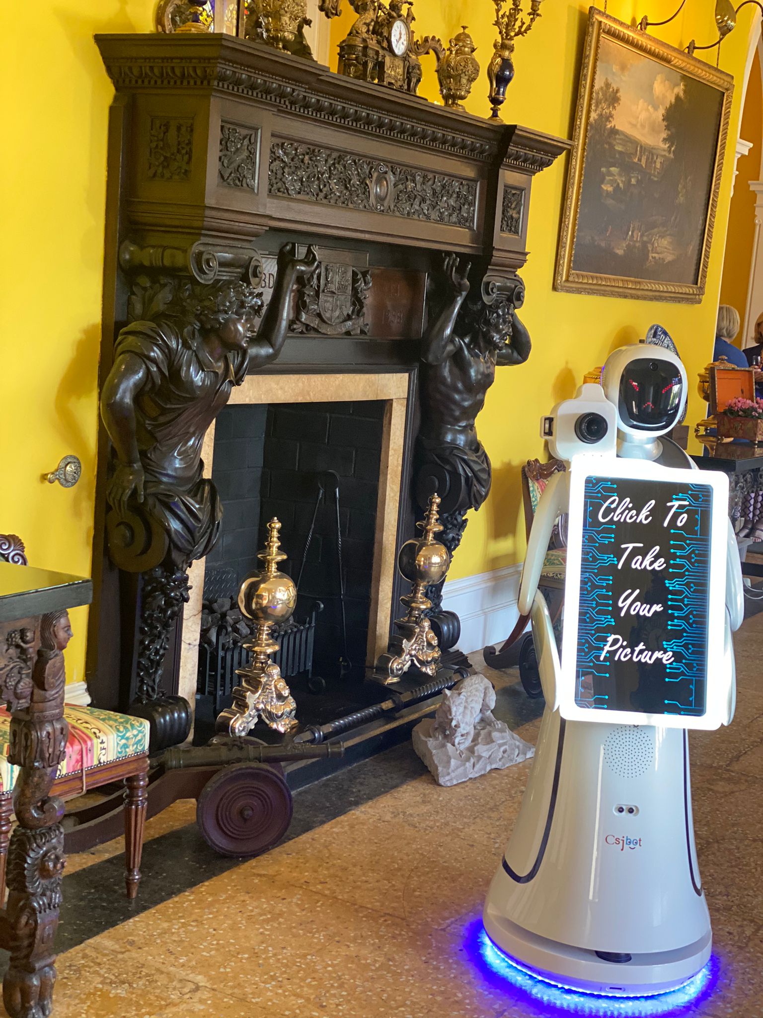 robot photo booth in front of fireplace at event