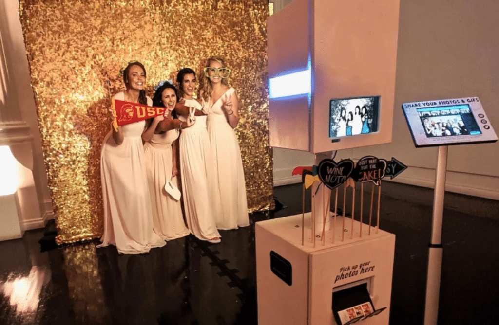 Ladies in front of photo booth pod for Setting Up Photobooth Small Business That Works Post